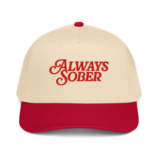 a bone colored hat with red writing and a red brim 
